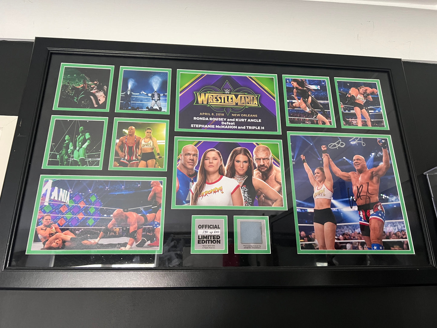 Signed WWE WrestleMania 34 Plaque (Autographed by Ronda Rousey and Kurt Angle) 140/500